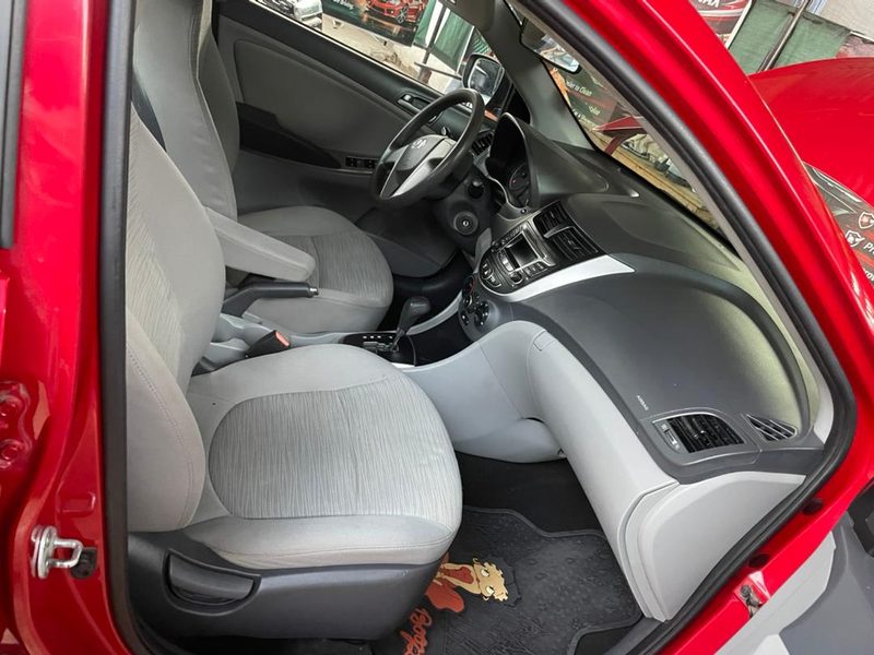 Detailed beige Hyundai cabin with clean cloth seats and branded floor mats
