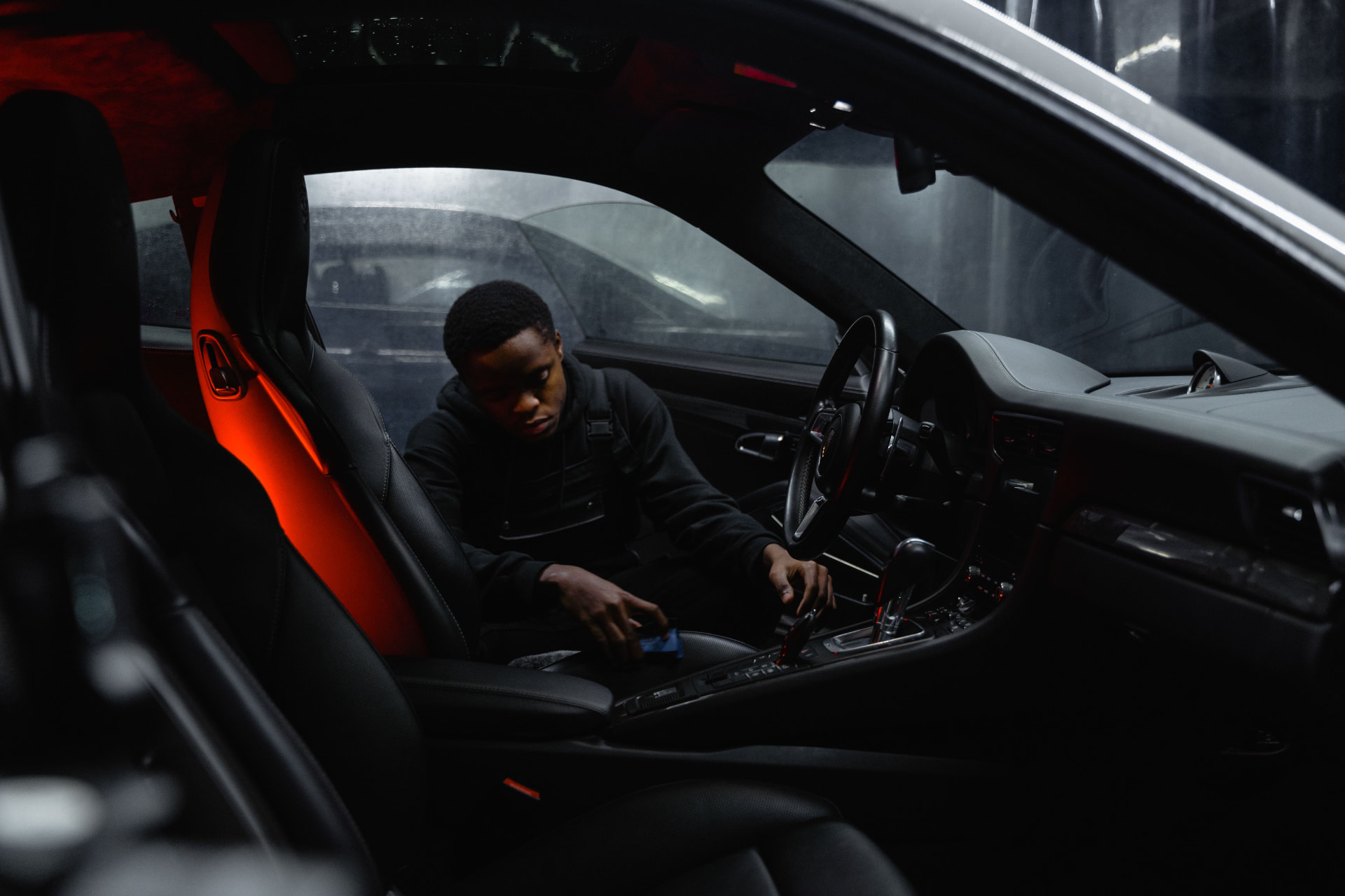 Interior detailing service - detailer deep cleaning a car's center console