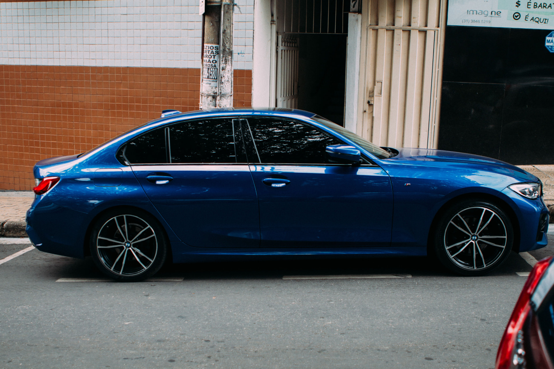 Window tinting service - blue sedan with dark tinted windows